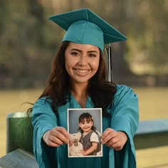 a woman in a cap and gown holding a photo