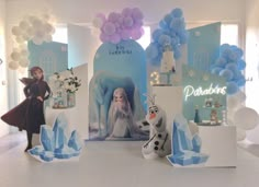 an ice princess themed birthday party with balloons, decorations and paper snowman figurines