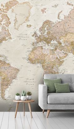 a living room with a couch, coffee table and large wall map