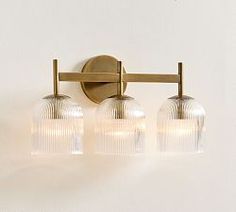 three light bathroom fixture with frosted glass globes on the front and back sides