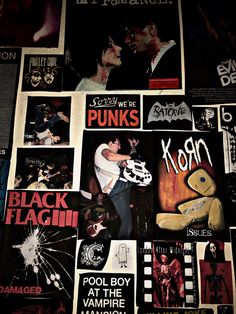 a wall covered in posters and stickers with the words punks on each side