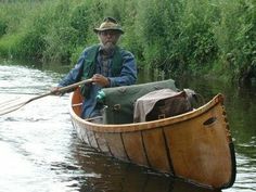 an old man in a canoe with two oars