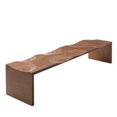 a wooden bench with wavy designs on it