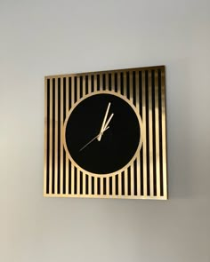 a black and gold clock hanging on the wall