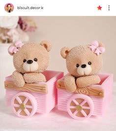 two teddy bears sitting on top of a pink cart with wheels and bows in it