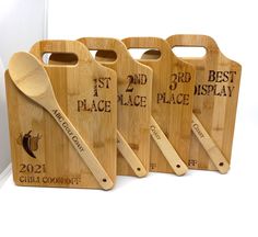 three wooden cutting boards with spoons on them and the words best place to eat engraved on them