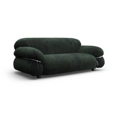 a dark green couch sitting on top of a white floor next to a black chair