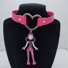 Handmade Ooak Draculaura Choker Necklace! Pink Vegan Leather Strap With Silver Heart Ring. Made With A Monster High Mega Bloks Draculaura Toy! 14" - 15.5" Adjustable Snap Closure. Cute And Weird (In The Best Possible Way)! Brand New, Never Worn. Keywords: Monster High Student Fairy Kei Fairycore Faecore Fairywave Cute Anime Original Weird Unique Funny Gift Kawaii Toy Harajuku Cartoon Pastelgoth Pastel Bubblegoth Bubble Upcycled Repurposed Recycled Rave Ravewear Decora Pink Black Vampire Dracula Pink Punk Style Necklace For Party, Adjustable Pink Jewelry For Cosplay, Pink Choker For Valentine's Day Gift, Pink Punk Jewelry For Party, Handmade Adjustable Choker For Cosplay, Pink Harajuku Style Jewelry For Parties, Pink Heart Choker As Gift, Handmade Punk Necklaces For Cosplay, Pink Punk Necklace For Party