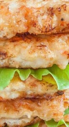 two chicken patties stacked on top of each other with lettuce and cheese