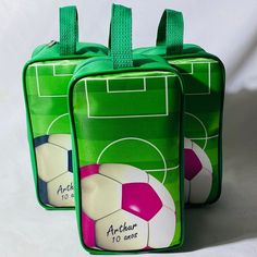 two green bags with soccer balls on them