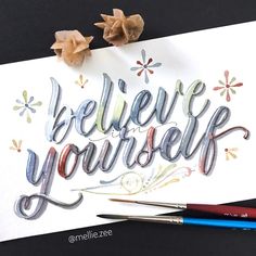 a piece of paper with the words believe yourself written on it and two crayons next to it