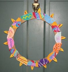 a paper plate wreath is hanging on the door