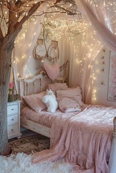 a bedroom with lights strung from the ceiling and a canopy bed in the corner, next to a tree