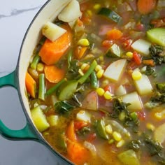 a pot full of vegetable soup sitting on top of a counter