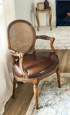 a brown leather chair sitting in front of a fire place next to a white fireplace