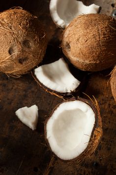 coconuts cut in half on a wooden table