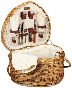 a wicker picnic basket with utensils in it