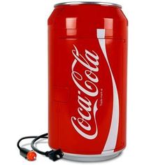 a coca - cola can is plugged into a charger