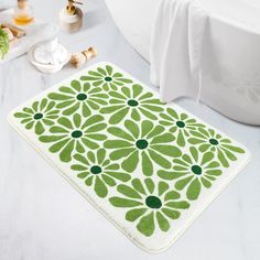 a green and white bath mat sitting on top of a bathroom counter