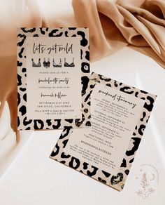 an animal print wedding suite is displayed on a white surface with black and gold accents