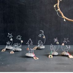 a group of metal objects sitting on top of a table next to a tree branch