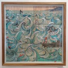 a painting on display in a museum with an ocean scene painted on the wall behind it