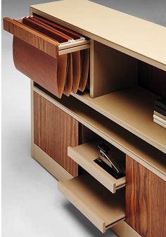 an office desk with several file folders and a pen in it's drawer