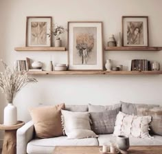 a living room filled with lots of furniture and pictures on the wall above it's shelves