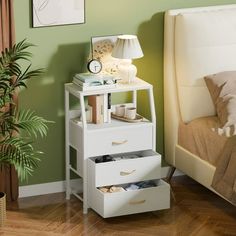 a bedroom with green walls and white furniture