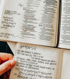 two open bibles with handwritten text on them