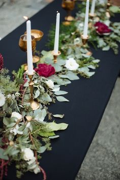 a long table with candles and flowers on it