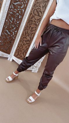 Upgrade your casual look with Leather Joggers. These stylish pants blend comfort with an edgy twist. Pair them with your favorite tops for a trendy outfit, whether you're running errands or hitting the town. Faux leather joggers Elastic cover waistband Elastic band ankle Pockets Fabric: 55% PU 45% VISCOSE MEASUREMENTS:S: 27 InchesM: 28 InchesL: 28.5 Inches Model Specs: Emily is wearing a size small in the photo.How will this item fit you? Check out our MODEL SPECS (Typical Sizing - Karli: S-Size Faux Leather Joggers, Leather Joggers, Stylish Pants, Everyday Chic, Trendy Outfit, Daily Activities, Chic Boutique, Long Hoodie, Vibrant Red