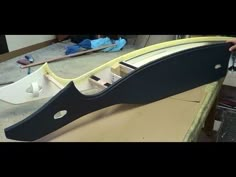 a man is making a boat out of plywood