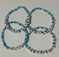 four bracelets with words that spell out the word's name and are made from beads