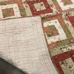 an old quilt is laying on the floor