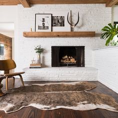 a living room with a fireplace and pictures on the wall