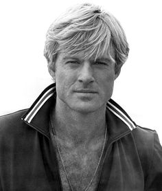 a black and white photo of a man with blonde hair wearing a adidas jacket