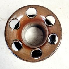 a close up of a metal object with holes in it