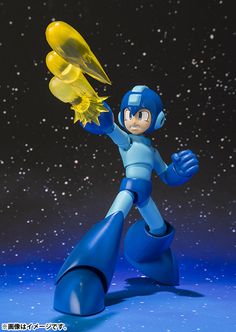 an action figure holding a yellow object in his hand on a blue surface with stars