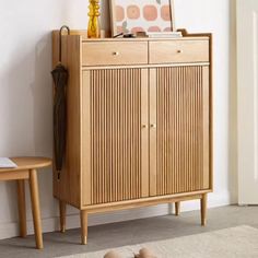 a wooden cabinet sitting in the corner of a room