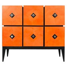 an orange and black dresser with six drawers