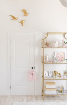 a room with white walls and shelves filled with items