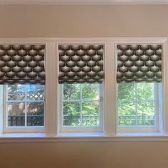 three windows with different shades in them