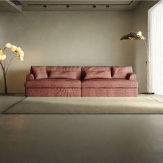 a living room with a pink couch and floor lamp