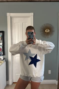 a person taking a selfie in front of a mirror wearing pajamas and holding a cell phone