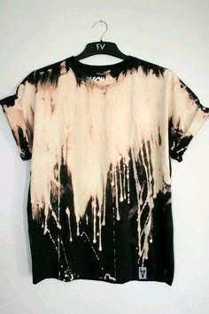 a black and white tie dye shirt hanging on a hanger