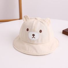 Get Ready for Adorable Adventures with Our Lovely Kids Bear Decor Panama Bucket Hat! Introducing our Kids Bear Decor Panama Bucket Hat a charming and practical addition to your little one's wardrobe. Crafted from a blend of soft cotton and durable polyester, this cartoon-themed Hat is designed to keep your child comfortable and stylish throughout the day. Product Features: Material: Cotton/Polyester blend Head circumference: Approximately 48CM Recommended age: Suitable for 6-24 months Top Type: Playful White Adjustable Bucket Hat, Adjustable White Playful Bucket Hat, Playful Adjustable White Bucket Hat, Cute Cotton Bucket Hat, White Bucket Hat For Playtime, Playful White Hat With Adjustable Fit, White Playful Hat With Adjustable Fit, Cute White Sun Hat For Playtime, Cute White Bucket Hat For Playtime