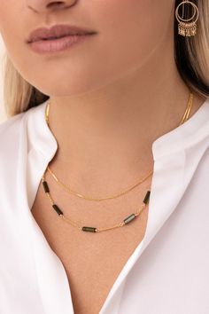 A double-stranded classic bar and link gold chain necklace accented with gorgeous green tourmaline stones. Short strand 16" / Long strand 18" (w/ 2" extender) Double Strand Gemstone Necklace For Layering, Luxury Double Strand Gemstone Necklace, Elegant Gold-tone Double Strand Necklaces, Double Strand 14k Gold-filled Chain Necklace, Luxury Double Chain Multi-strand Necklace, Classic Bar, Blue Tourmaline, Tourmaline Stone, Tourmaline Necklace