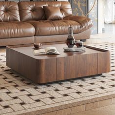 a brown leather couch sitting on top of a wooden coffee table