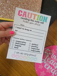 a person holding up a paper that says caution reading this note will make you smile